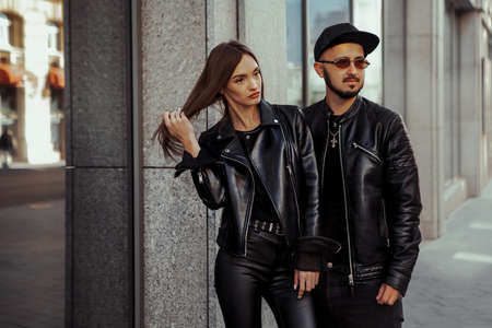 beautiful couple walks across the road in the streetの写真素材