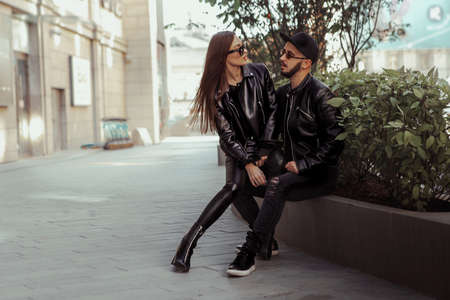 beautiful couple walks across the road in the streetの写真素材