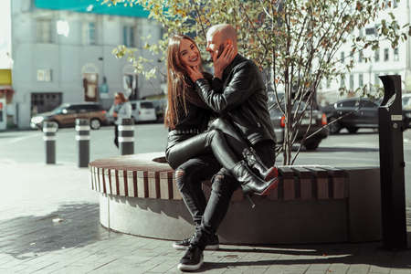 beautiful couple walks across the road in the streetの写真素材