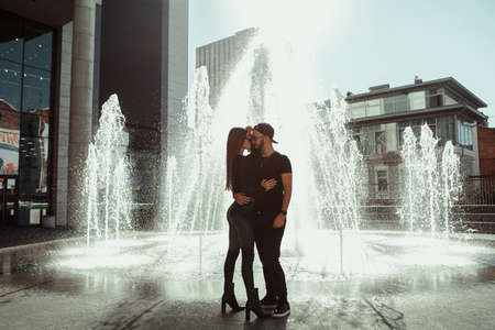 beautiful couple walks across the road in the streetの写真素材