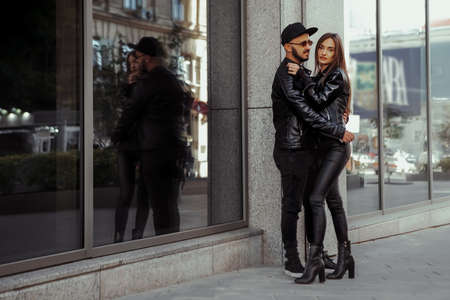 Vertical portrait of gorgeous couple walks across the roadの写真素材