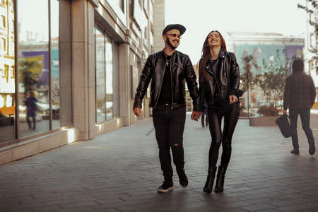 Adorable couple in sunglasses hugs in the cityの写真素材