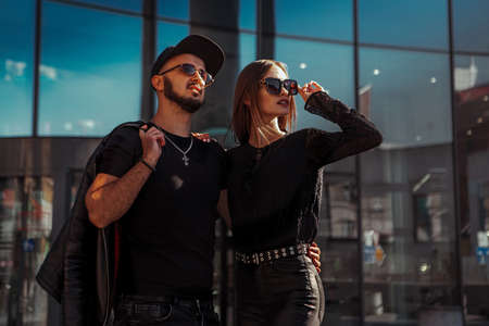 Adorable couple in sunglasses hugs in the cityの写真素材