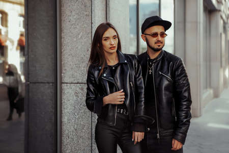 Adorable couple in sunglasses hugs in the cityの写真素材