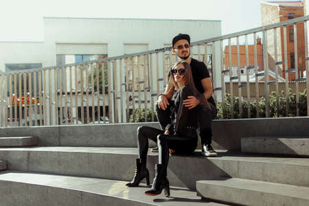 Vertical portrait of gorgeous couple walks across the roadの写真素材