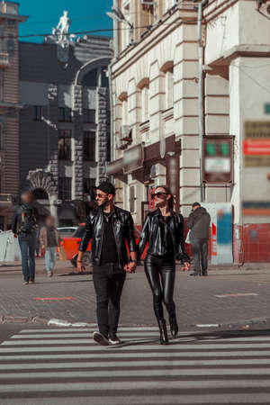 Vertical portrait of gorgeous couple walks across the roadの写真素材