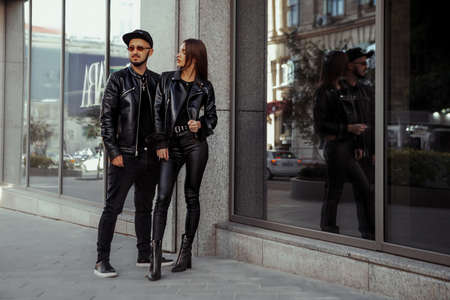 Beautiful woman in leather suit and sunglasses posing in the streetの写真素材