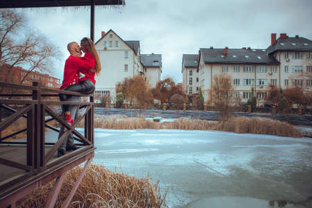 horizontal portrait of beautiful couple hugs on a balcony winter time. Christmas moodの写真素材