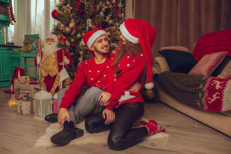 horizontal portrait of beautiful couple hugs on a balcony winter time. Christmas moodの写真素材