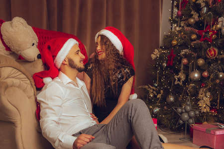 horizontal portrait of beautiful couple hugs on a balcony winter time. Christmas moodの写真素材
