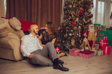 horizontal portrait of beautiful couple hugs on a balcony winter time. Christmas moodの写真素材