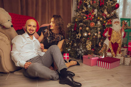 Cheerful family with daughter celebrate New year and Christmas together at homeの写真素材
