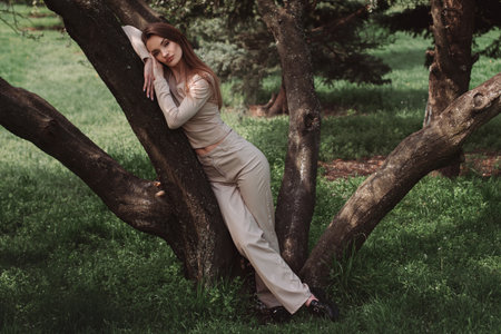 portrait of glamor young lady poing in the green forestの写真素材