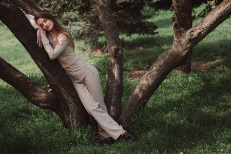 portrait of glamor young lady poing in the green forestの写真素材