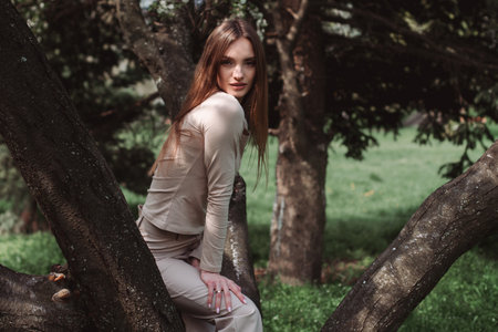 portrait of glamor young lady poing in the green forestの写真素材