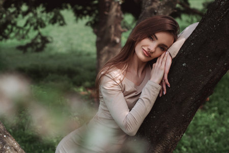 portrait of glamor young lady poing in the green forestの写真素材