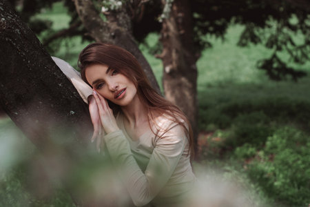 portrait of glamor young lady poing in the green forestの写真素材
