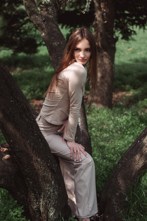 portrait of glamor young lady poing in the green forestの写真素材