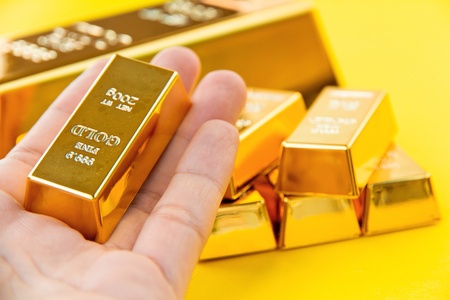 Hand hold gold barsの写真素材