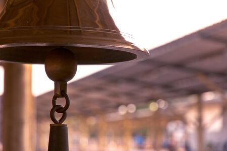 old bell in train station with sunrise lightの写真素材