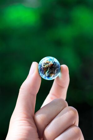 hand keep the world の写真素材