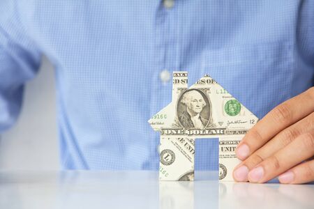 Hand holding banknote house icon の写真素材