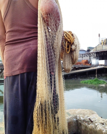 Fisherman pulling in his Fishing Net の写真素材