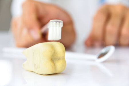 dentist holding brushing teeth, dental hygiene conceptの写真素材