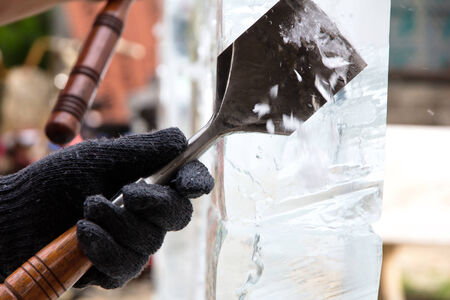 Ice Sculpture Carving,Ice Carver Using Chisel to Carve の写真素材