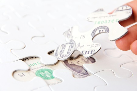 hand holding a puzzle piece, Finance concept の写真素材