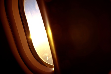 Airplane window with sunsetの写真素材