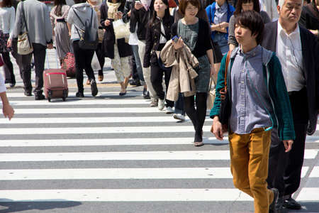 Tokyo, Japan - April15, 2014   Tourists and business people crossing the street at Shibuya in April15, 2014, the most important commercial center in Tokyo, Japan のeditorial素材
