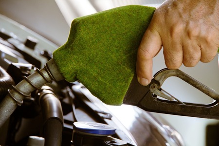 Hand holding green fuel nozzle,energy conceptの写真素材