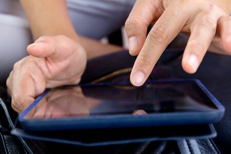 business woman working on digital tablet close up