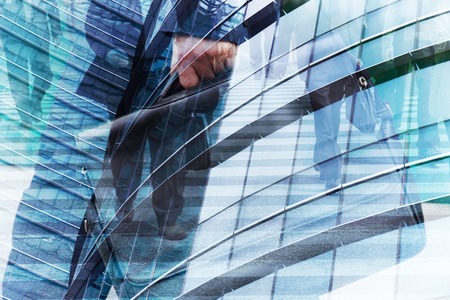 Abstract double exposure of businessman and office buildings, rush hours conceptの写真素材