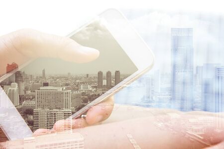 Double exposure of hand with mobile phone