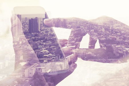 Double exposure image of people with smart phone and cityscape background,Business technology...
