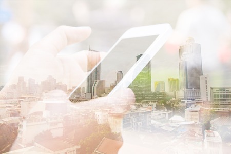 Double exposure image of people with smart phone and cityscape background,Business technology concept.の写真素材