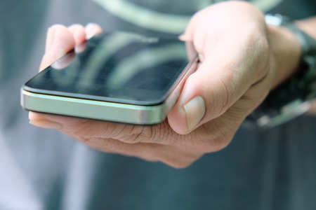 Close up of Man Hand holding Smart Phoneの写真素材