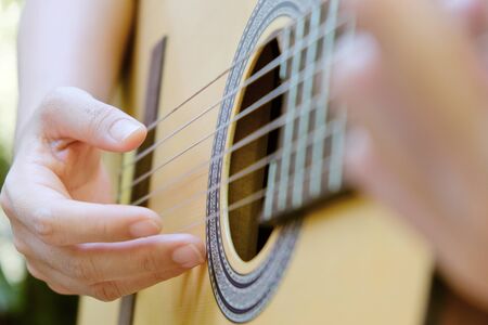 Close up image of Man playing his classic guitar backgroundの写真素材