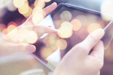 Multiple exposure of tablet and Bokehの写真素材