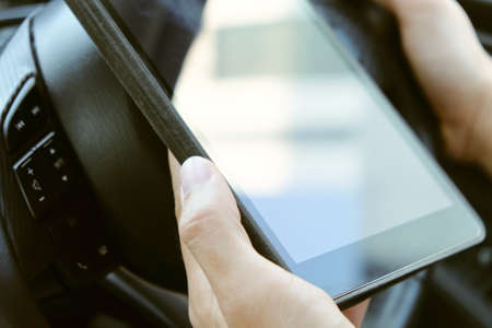 image of using a digital tablet inside of a car.の写真素材