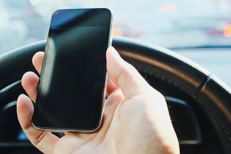 The use of mobile phones in the car and the traffic jam on the outside. urban lifestyle and communication technology concept.の写真素材