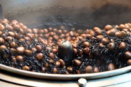 Chestnut roasting,Chestnut snacks are famous and popular in Yaowarat Road  Chinatown of bangkokの写真素材