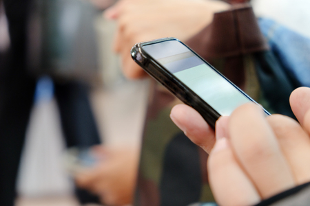 Close up image of businessman  hand text messaging on his phone in subway,Social media lifeの写真素材