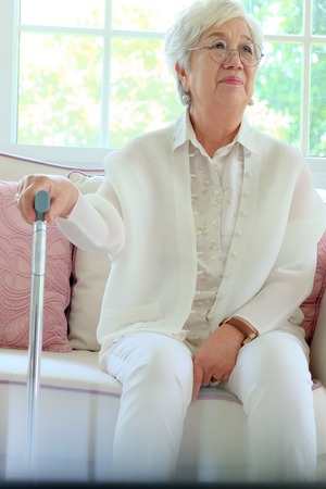 Retired woman with her walking stickの写真素材