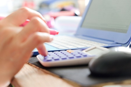 Business woman using the calculator.,working time