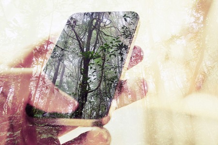 concept image of Digital composite using cell phone in forestの写真素材