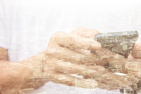 Double exposure of man using smart phone and cityscape background ,Business technology concept.の写真素材
