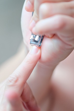 Woman cutting nailsの写真素材